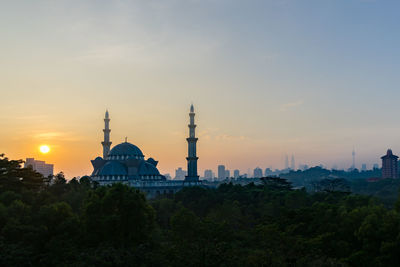 Federal territory mosque against sky during sunset