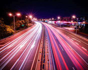 High angle view of light trails on highway at night