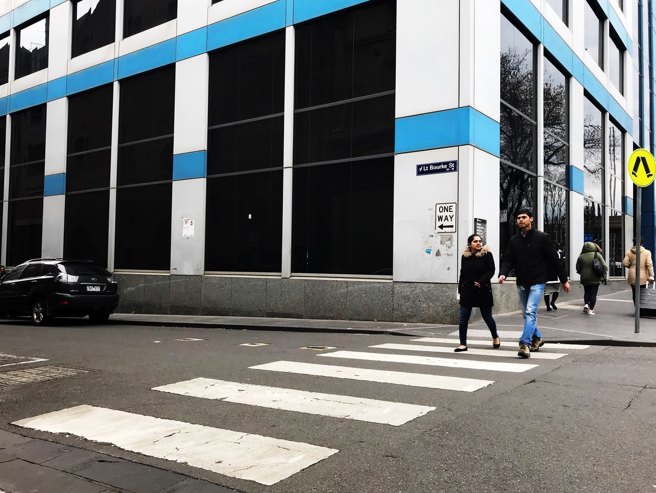 PEOPLE WALKING ON CITY STREET