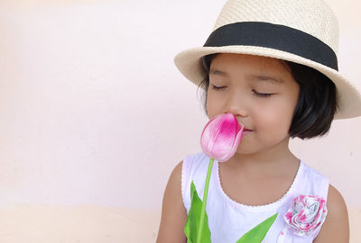 Low angle view of girl against pink wall