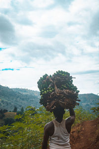 Rear view of woman standing on mountain