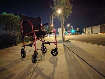 Bicycles against illuminated sky at night