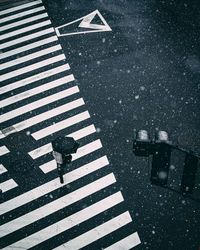 High angle view of person with umbrella walking on crosswalk