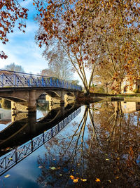 Arch bridge over river against sky