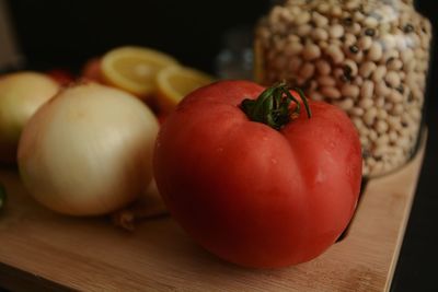 Close-up of tomato and onion on cutting board