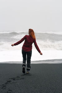 Redhead woman walking along northern beach scenic photography