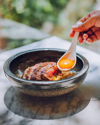 Cropped hand of person holding food