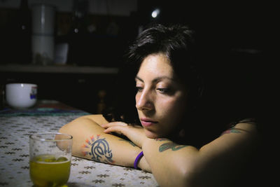 Portrait of young woman drinking glass