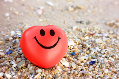 Close-up of heart shape stone on sand