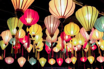 Low angle view of illuminated lanterns hanging at night