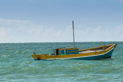 Scenic view of boat sailing in sea against sky