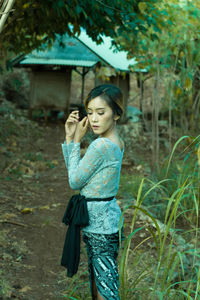 Side view of woman standing on field