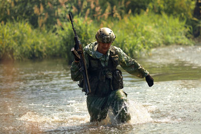 Full length of man standing in water