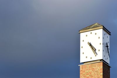 Low angle view of clock tower against sky