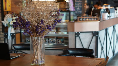 Close-up of flower vase on table in restaurant