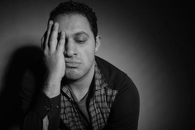 Portrait of young man against white background