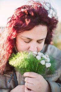 Portrait of woman holding flowers