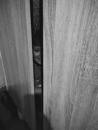 Close-up portrait of a boy hiding at home