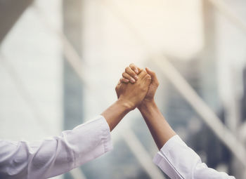 Cropped image of business people greeting each other outdoors