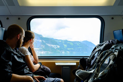 Rear view of people sitting in train