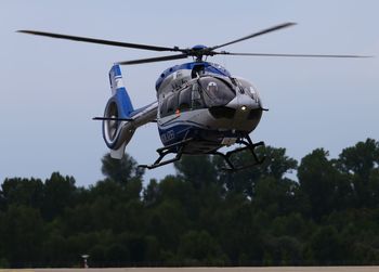 Low angle view of helicopter against sky