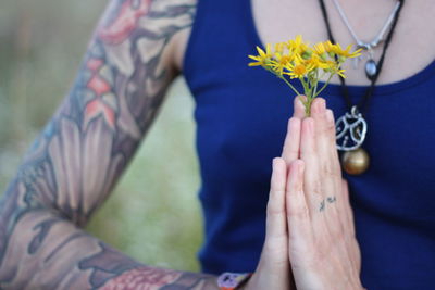 Midsection of woman holding flower bouquet