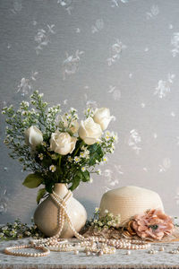 White roses in vase on table