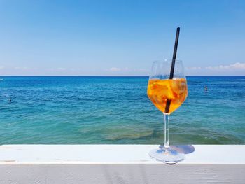 Close-up of water against sea against clear blue sky
