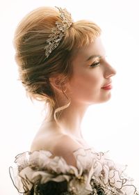 Portrait of beautiful young woman over white background