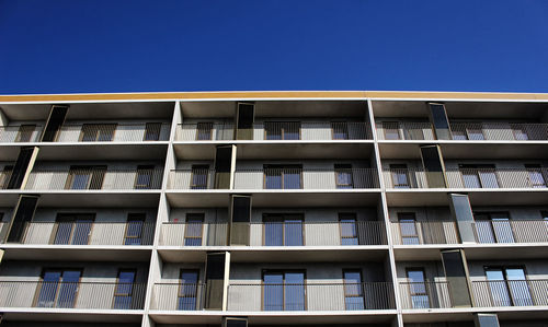 Low angle view of building against clear blue sky