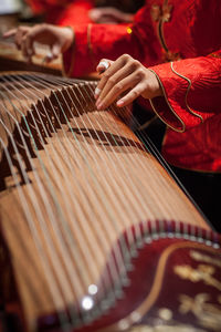 Midsection of woman playing string instrument