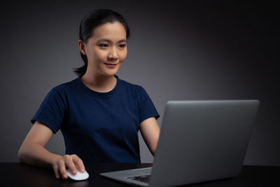 Portrait of teenage girl sitting on table