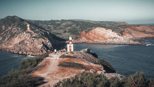 Scenic view of sea and mountain against sky