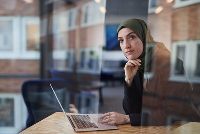 Woman in cafe looking at camera