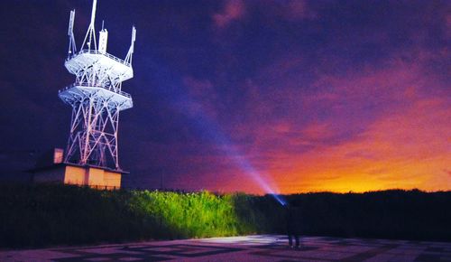 Illuminated built structure against sky at night