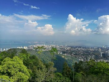 Panoramic view of sea and cityscape against sky