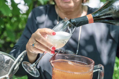 Cropped hand of woman holding drink