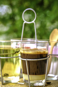 A glass of black coffee with condensed milk in retro style coffee shop, serving with hot tea