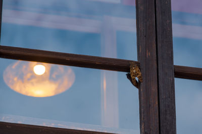 Close-up of metal door against sky