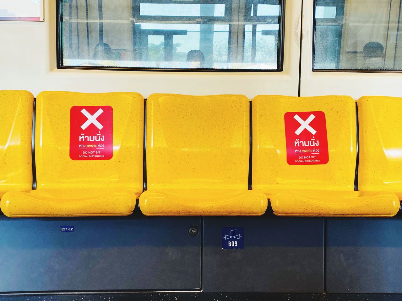 CLOSE-UP OF YELLOW TRAIN AGAINST WINDOW