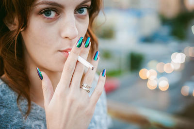 Close-up of woman burning cigarette