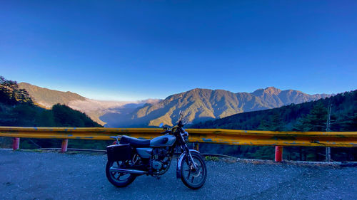 Scenic view of snowcapped mountains against clear blue sky