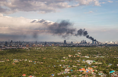 Smoke emitting from chimney against sky