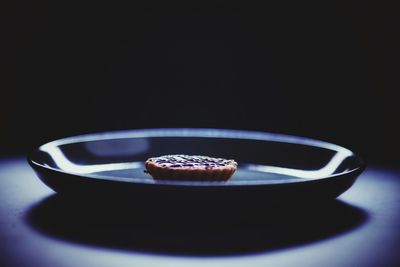 Close-up of coffee on table against black background