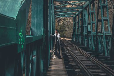 Side view of man on railroad track