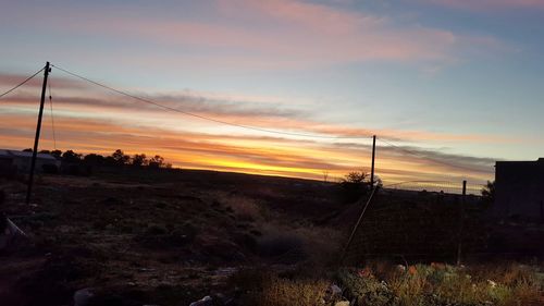 Scenic view of landscape against sky at sunset