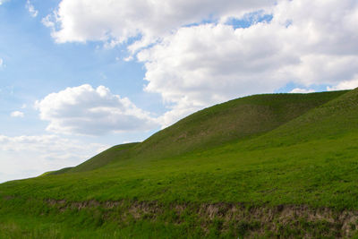 Scenic view of green landscape against sky