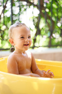 Portrait of cute baby boy in bathtub