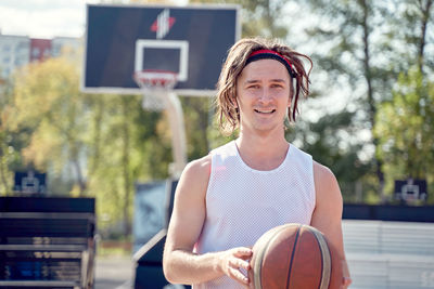 Portrait of basketball player standing outdoors