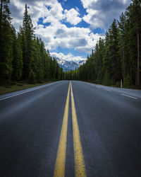 Road amidst trees against sky